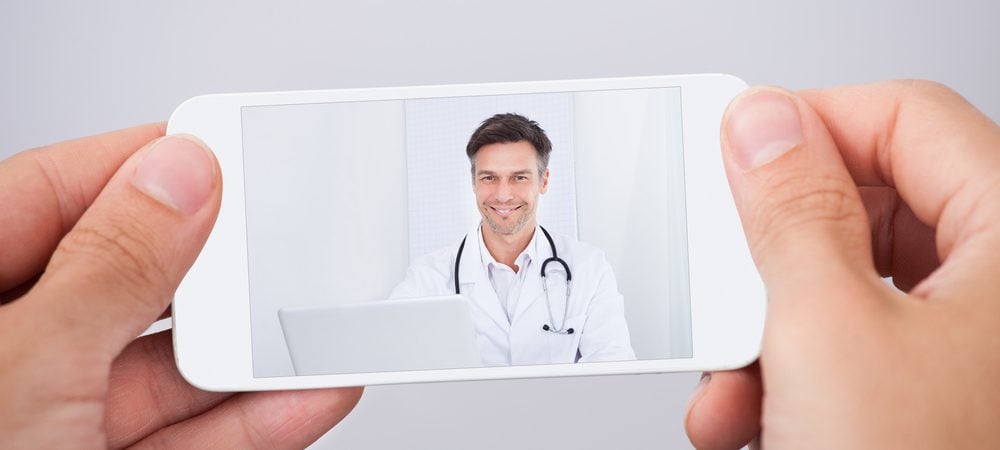 mobile phone featuring video of physician speaking to attract new patients for healthcare business