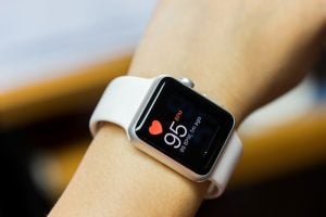 Apple smartwatch showing heartbeat rate on screen