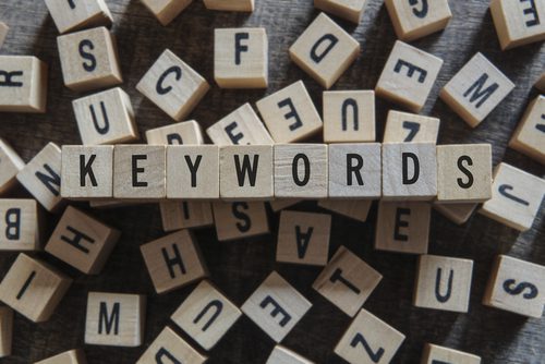 Wooden blocks spelling out "keywords" on table