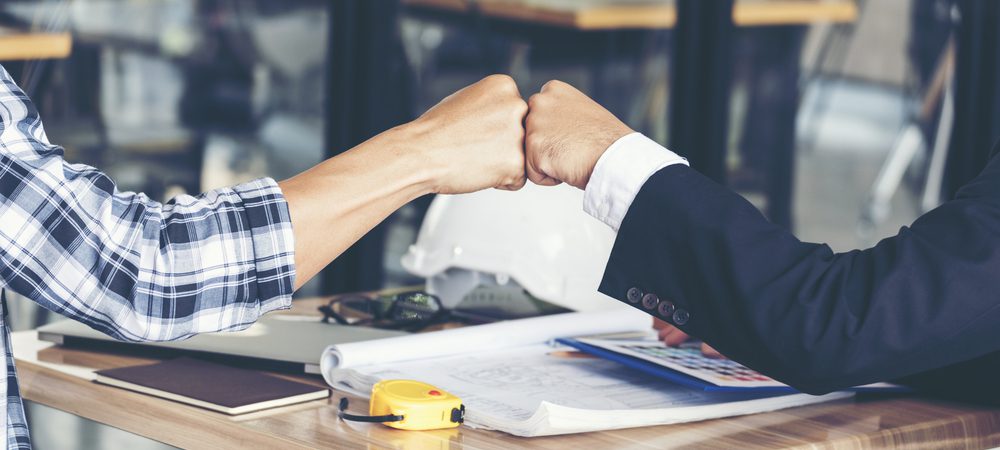 Financial services representative and customer sharing a fist bump