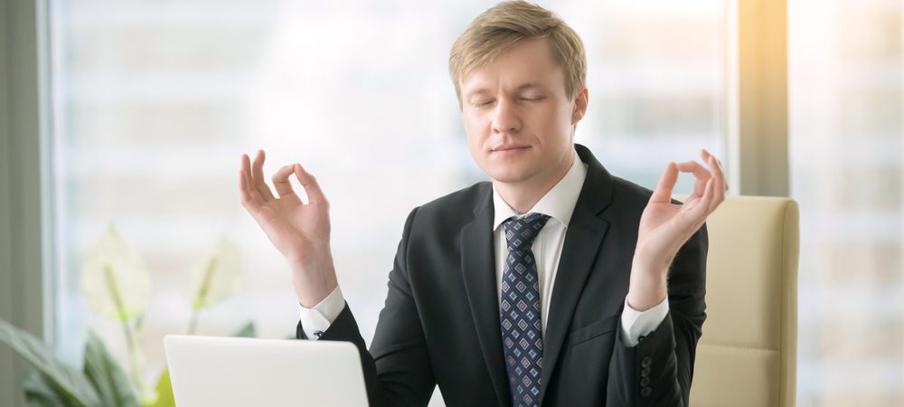 Executive at desk in a yoga pose