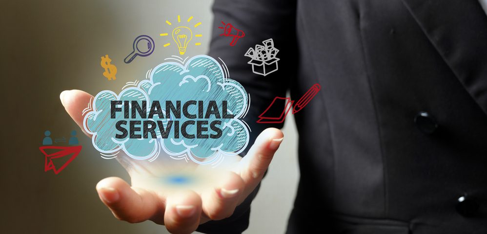 Business man holding a cloud with the words Financial Services inside it