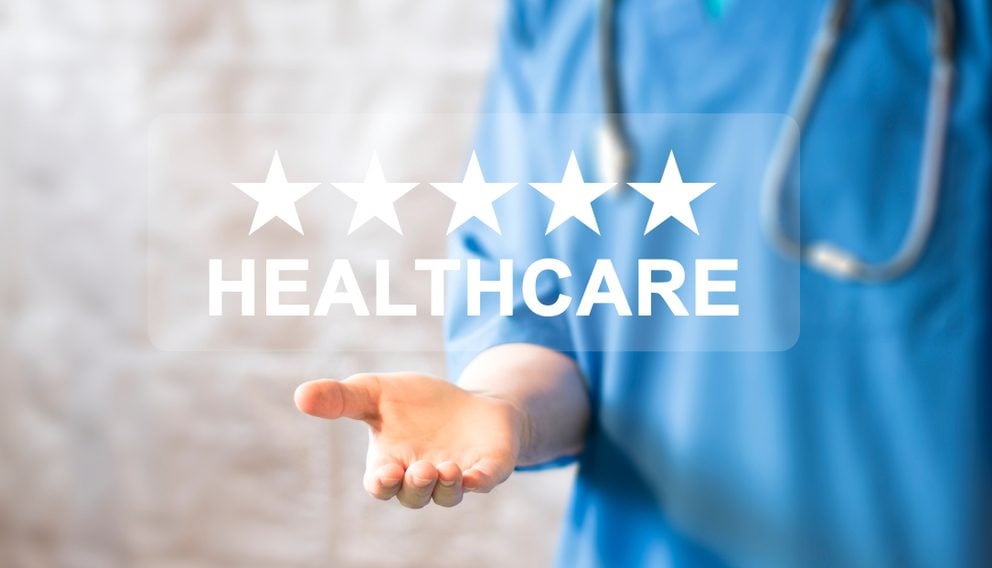 Health provider holding in their palm a five stars with the word Healthcare