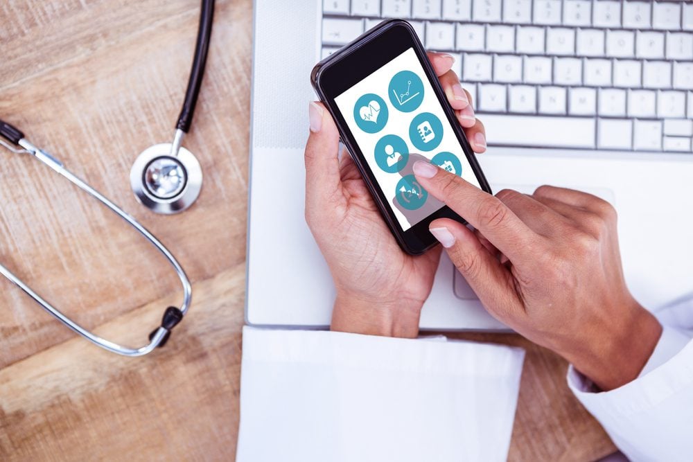 Healthcare professional accessing a health app on their mobile device