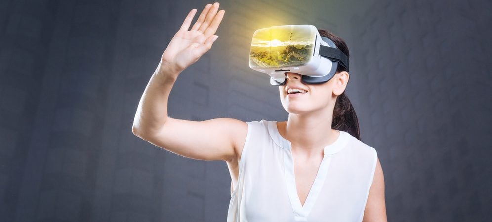 Woman looking through virtual reality goggles