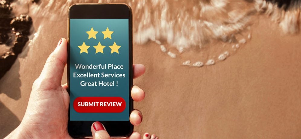 Person submitting a hotel review via smartphone.