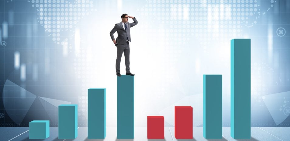 Man standing on top of a bar graph analyzing the points.