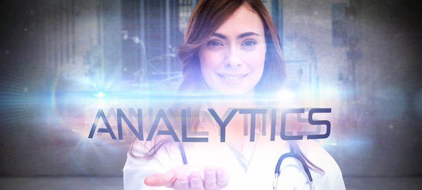 A doctor holding the word "Analytics" in her hand.