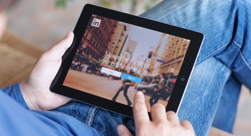 Tablet displaying the linkedin app on it.
