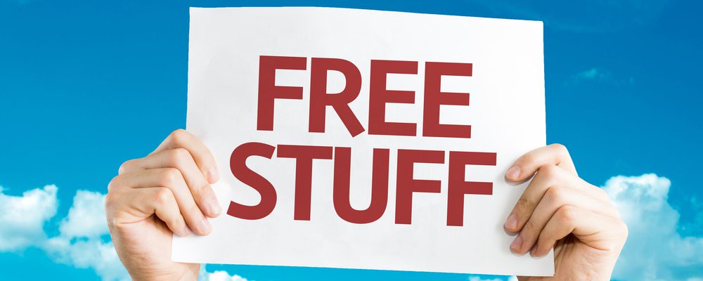 Hands holding up a sign that says "Free Stuff" on it.