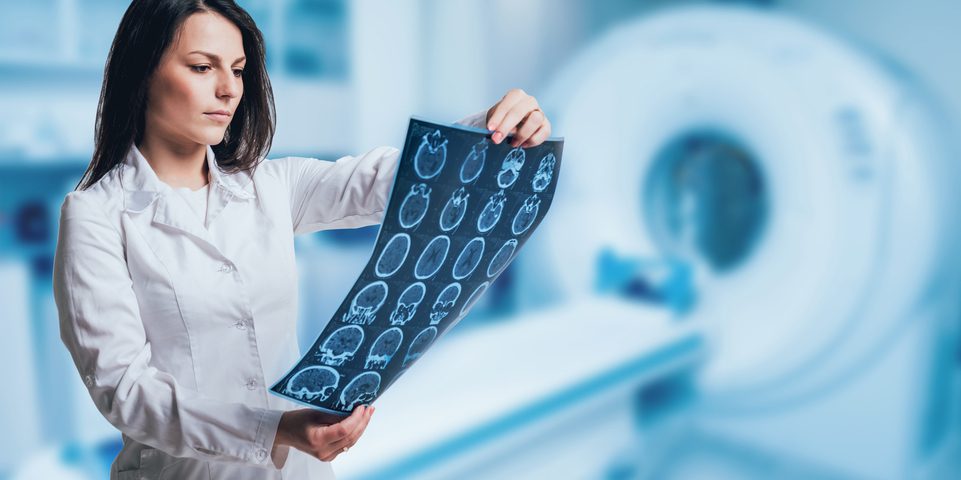 Female doctor looking at the results of an MRI.