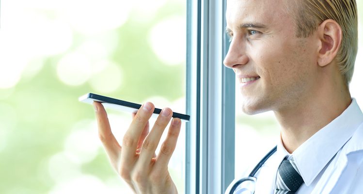 A doctor speaking into voice assistant on his mobile phone