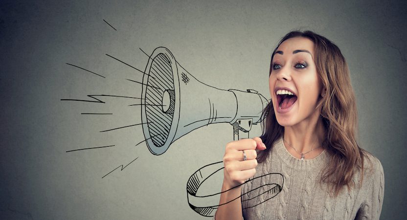 Woman happily talking through a megaphone.