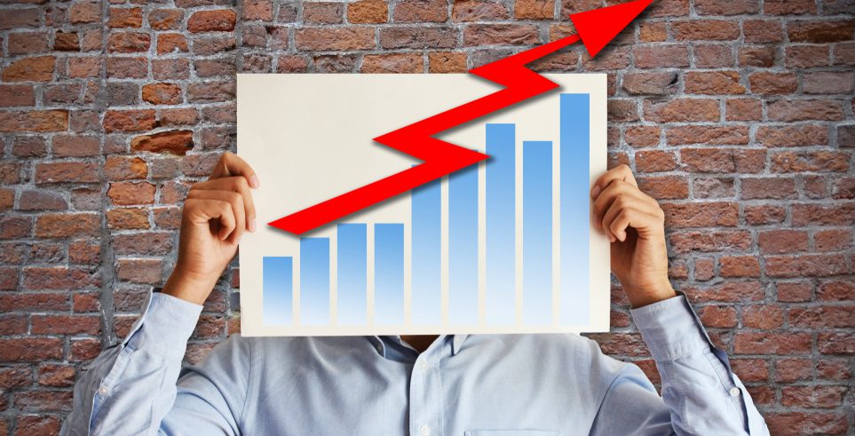 A man holding a bar graph in front of his face.