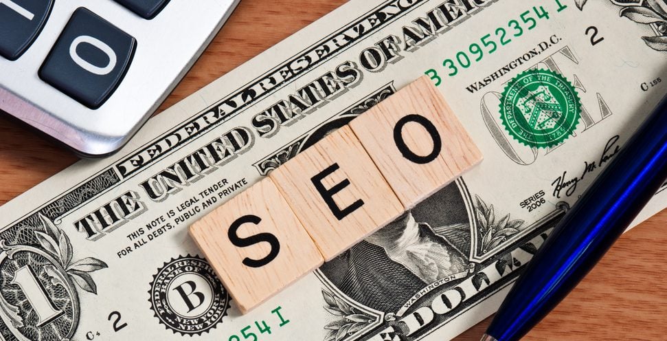 A one dollar bill with tiles on top of it spelling "SEO"