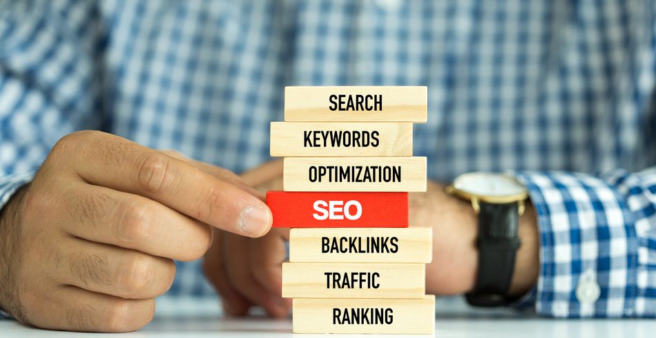 A stack of blocks with the words "Search", "Keywords", "Optimization", "SEO (Highlighted in Red)", "Backlinks", "Traffic", and "Ranking" stacked in that order.