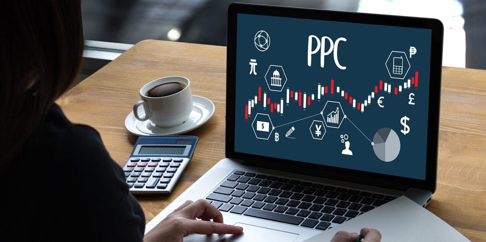 A laptop displaying "PPC" on it with analytic graphics.