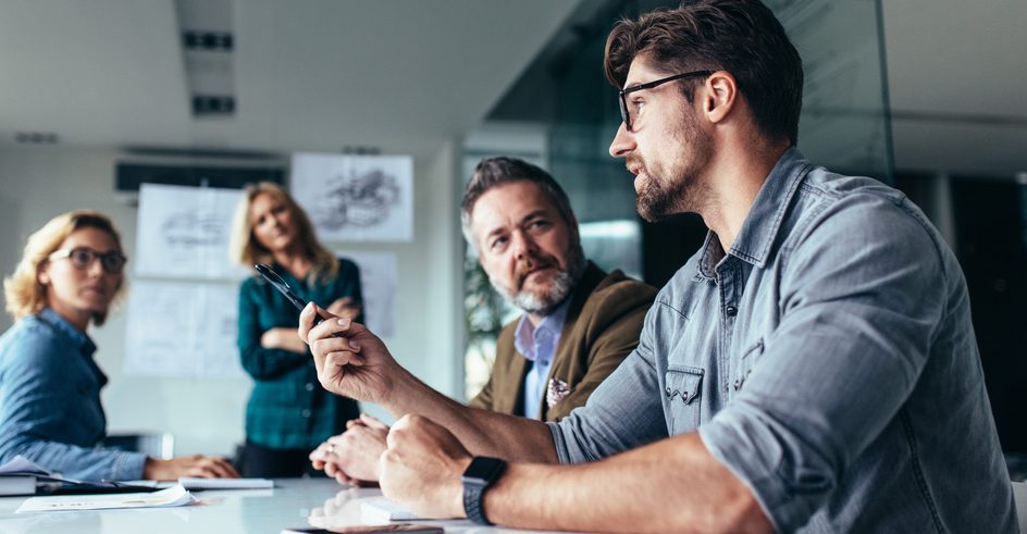 A group discussing together in a business room.