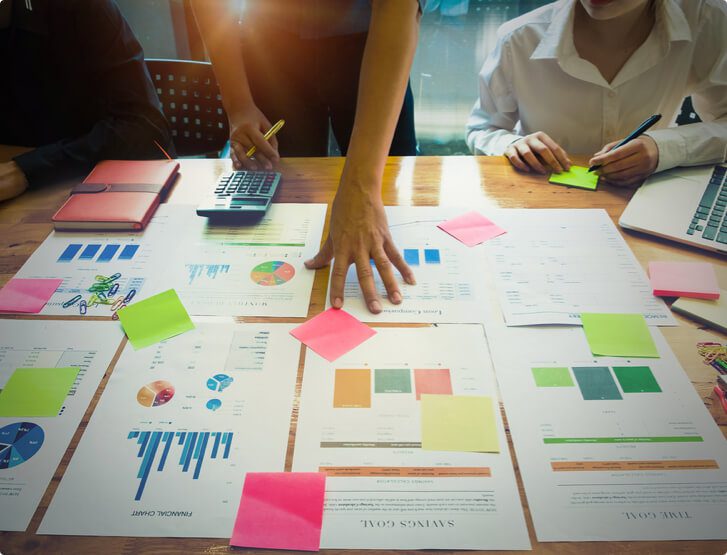 Woman keeping her hand on a table full of printed graphics