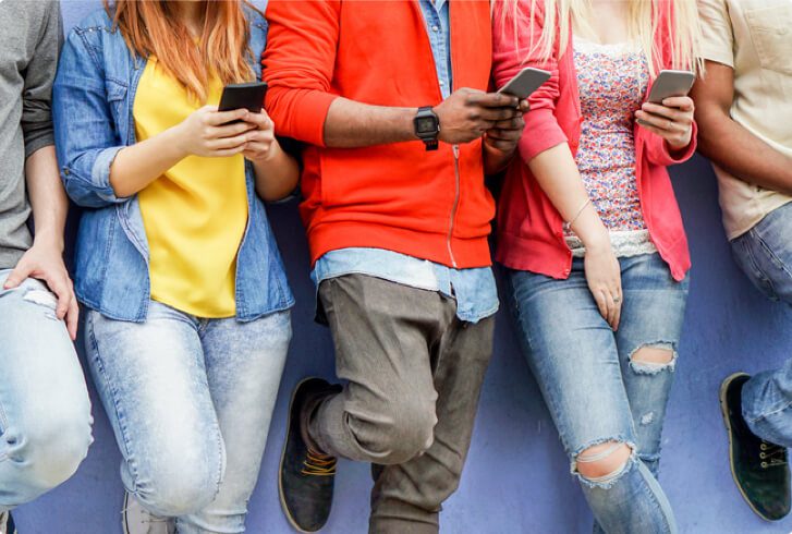 Group of people looking at their mobile devices