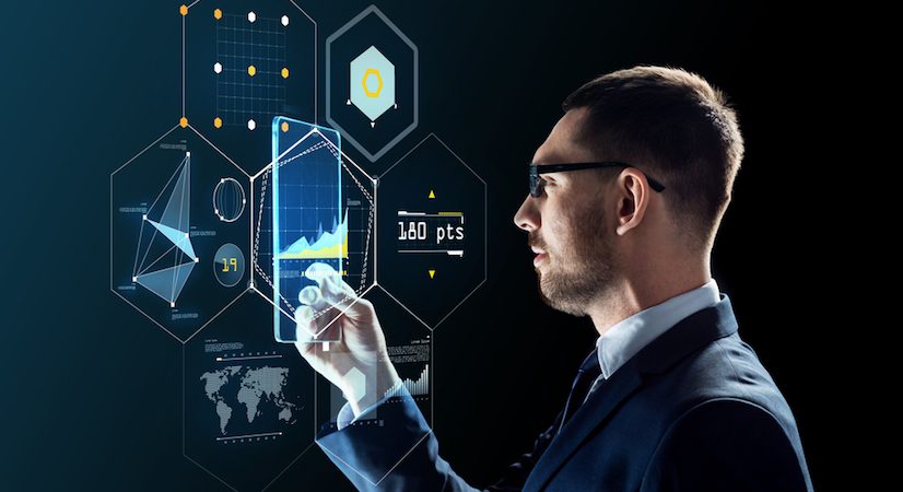 Business man looking at a hologram screen displaying various metrics