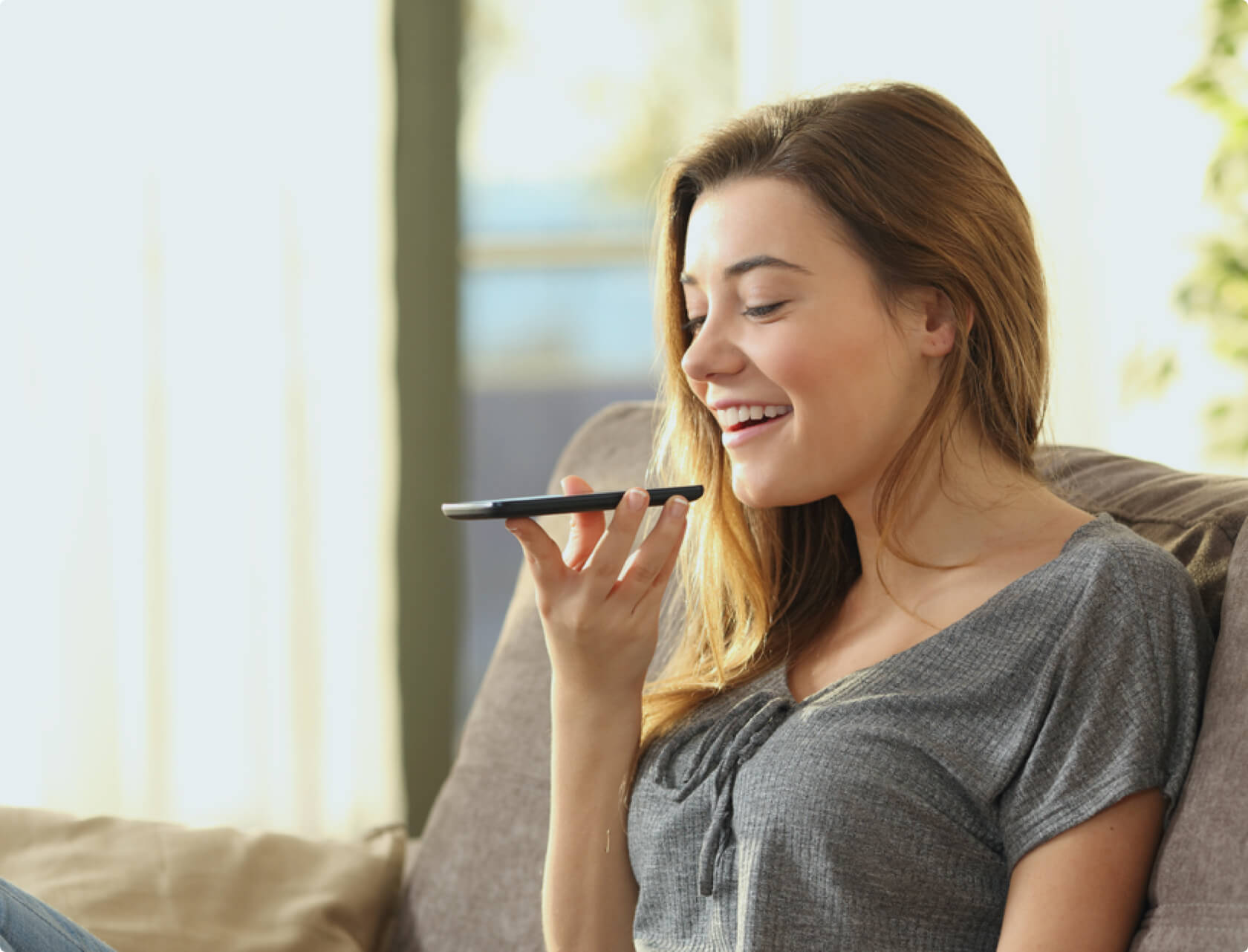 Young woman talking to her mobile device