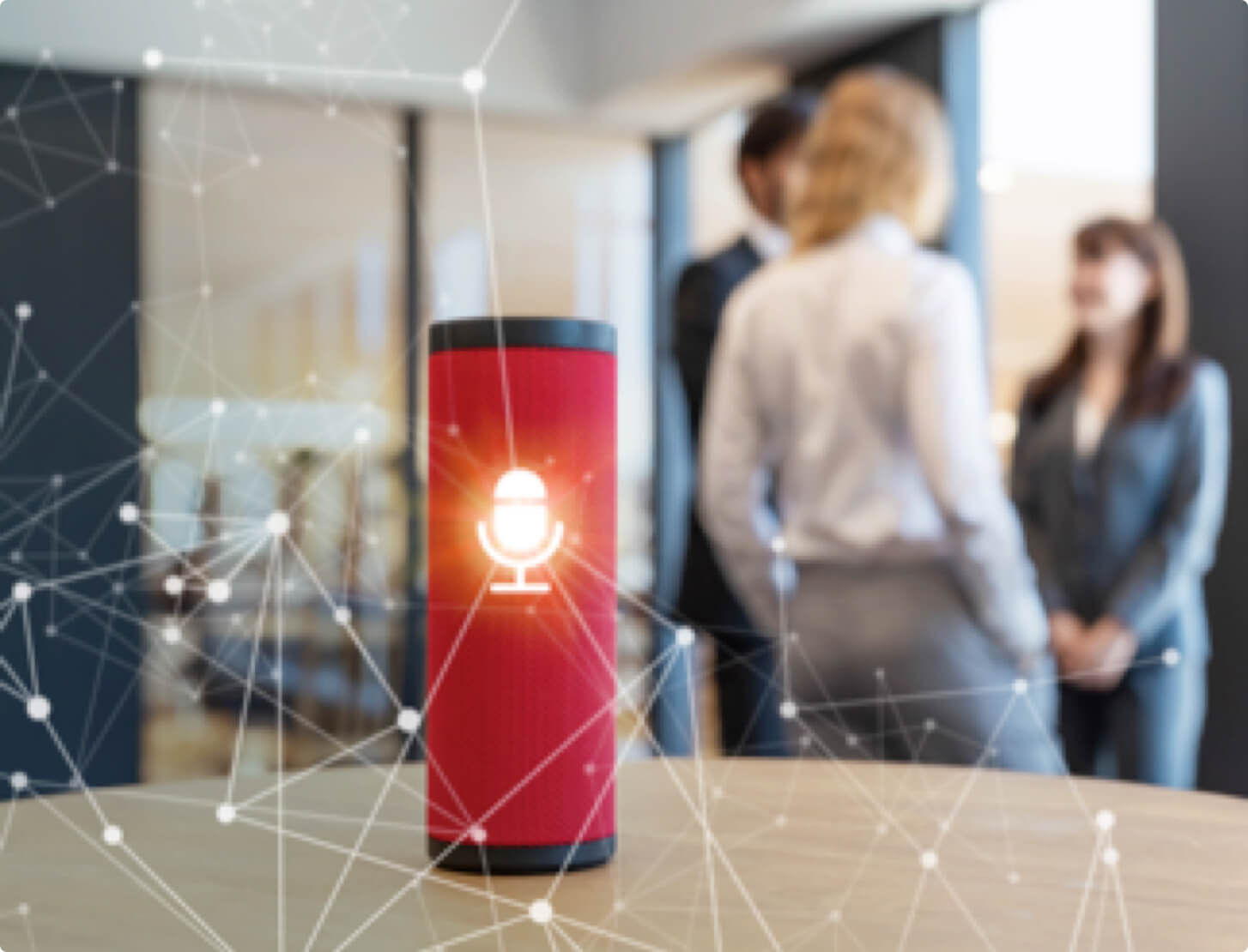 A red smart speaker on a table at work.