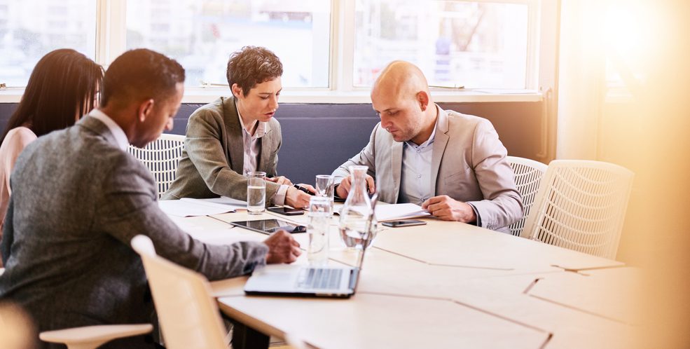 People discussing in a business room.