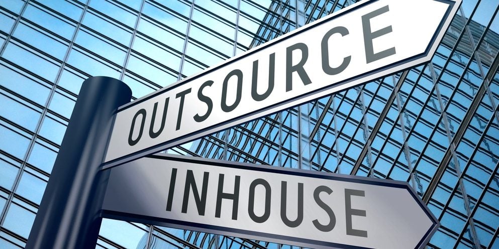 Street signs displaying the word "Outsource" on one and "Inhouse" on the other.