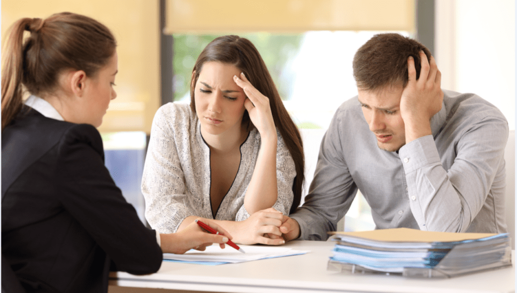 People at a table dealing with a business conflict.