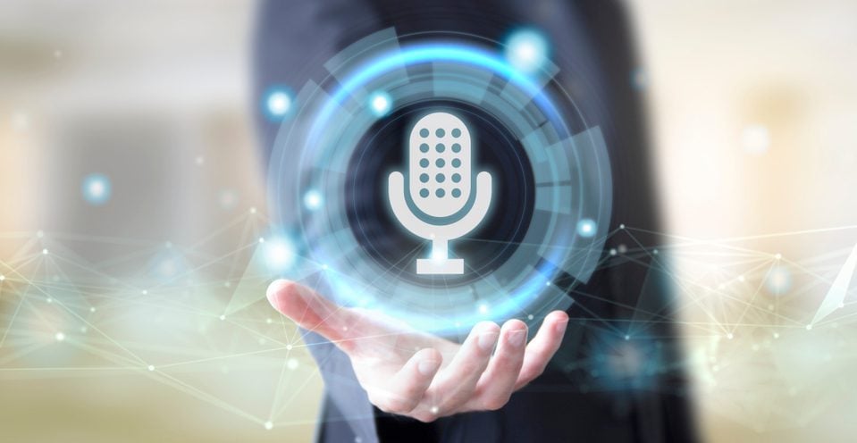 Business man holding the hologram of a microphone