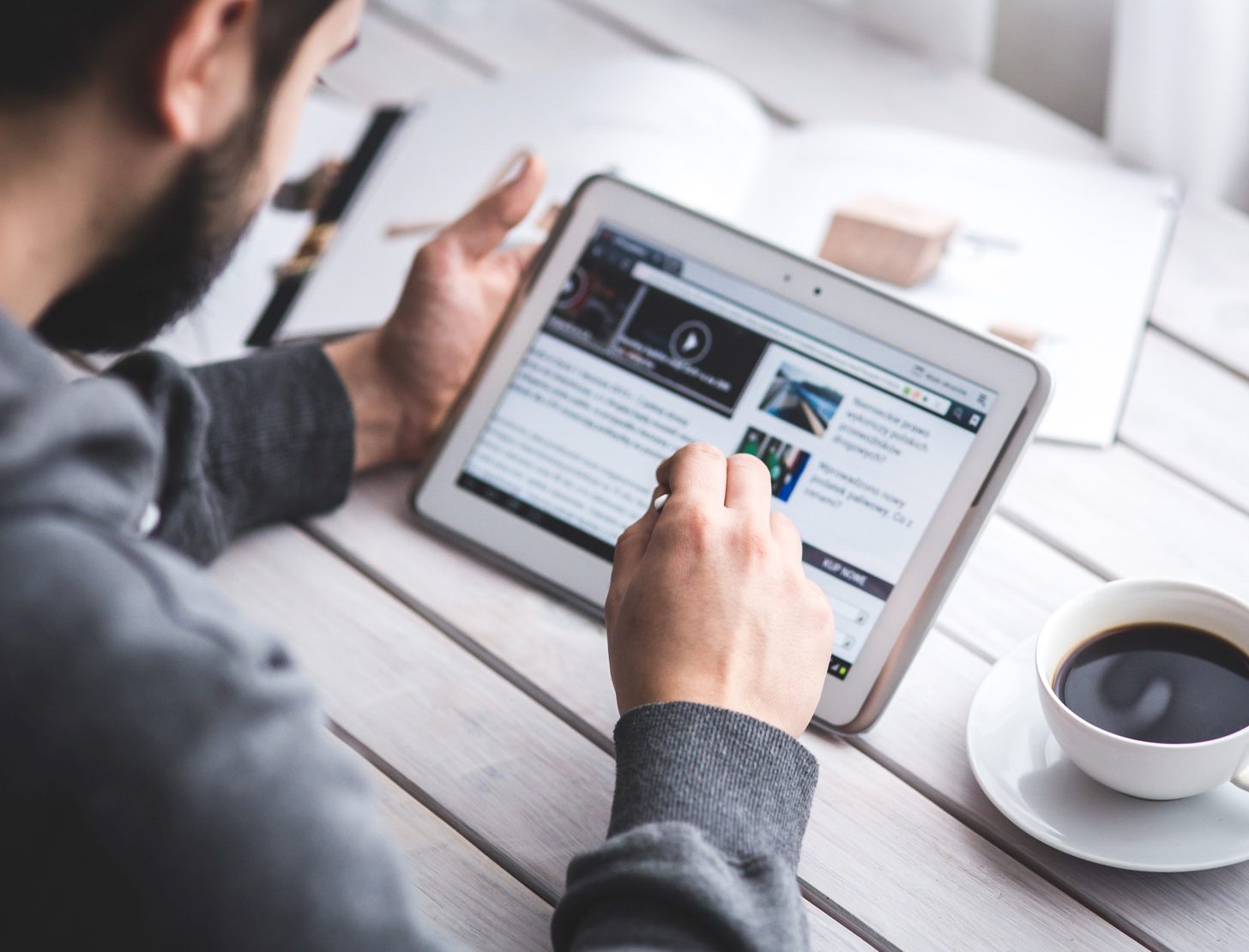 Man reading content on a tablet