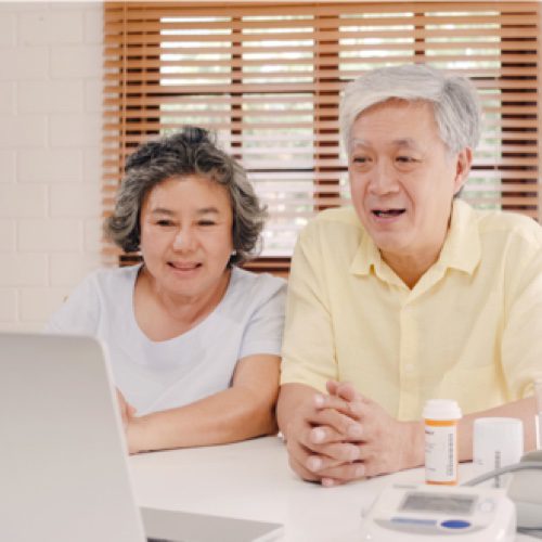 Elderly couple looking at a laptop