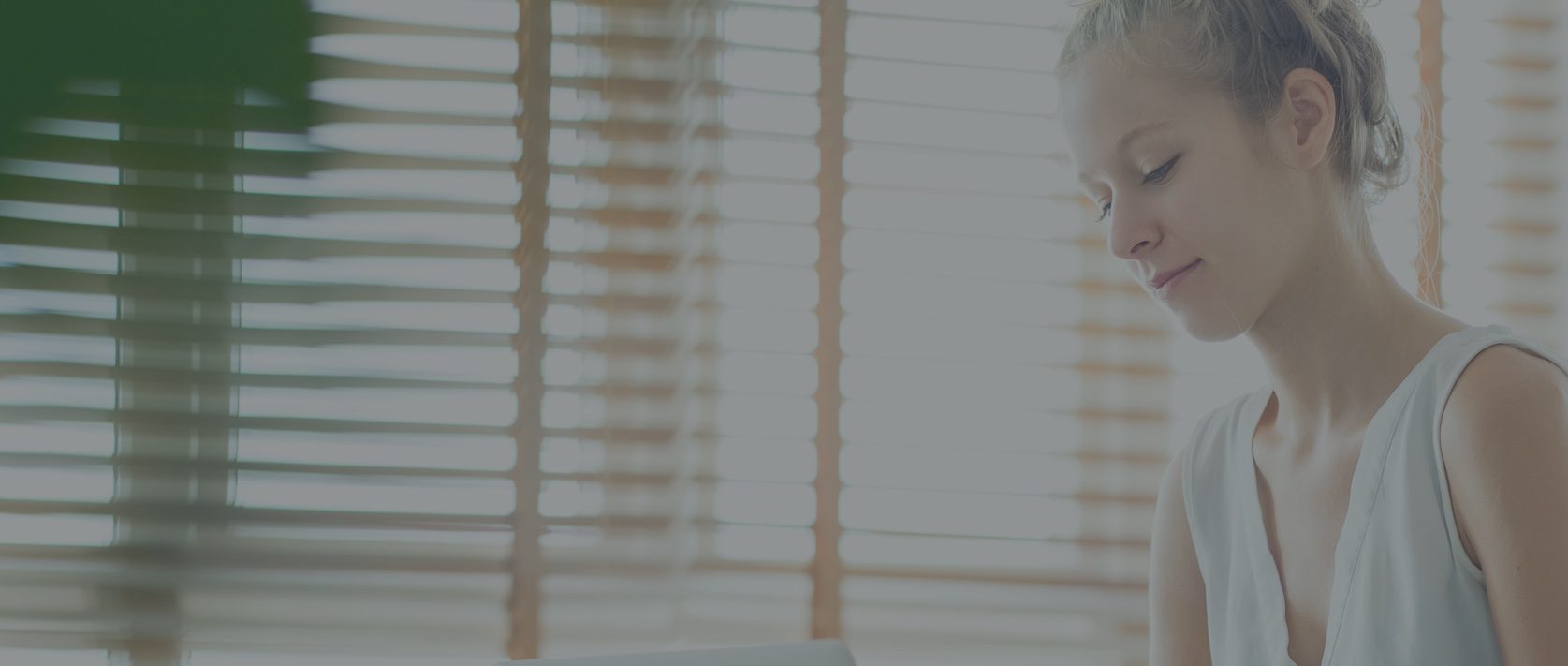 Woman smiling and looking at her laptop