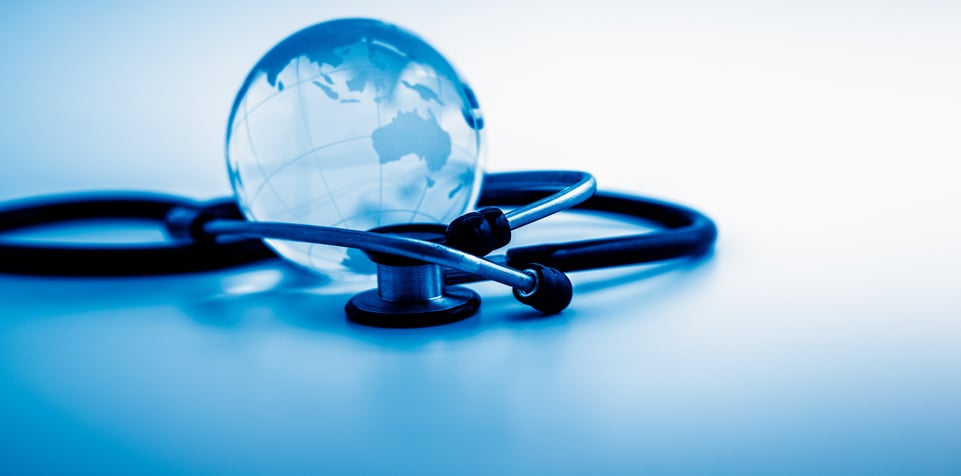 A stethoscope encircling a world globe ball