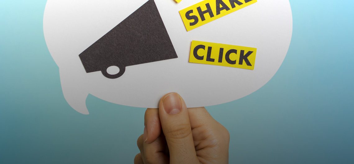 hand holding a marketing-related sign.