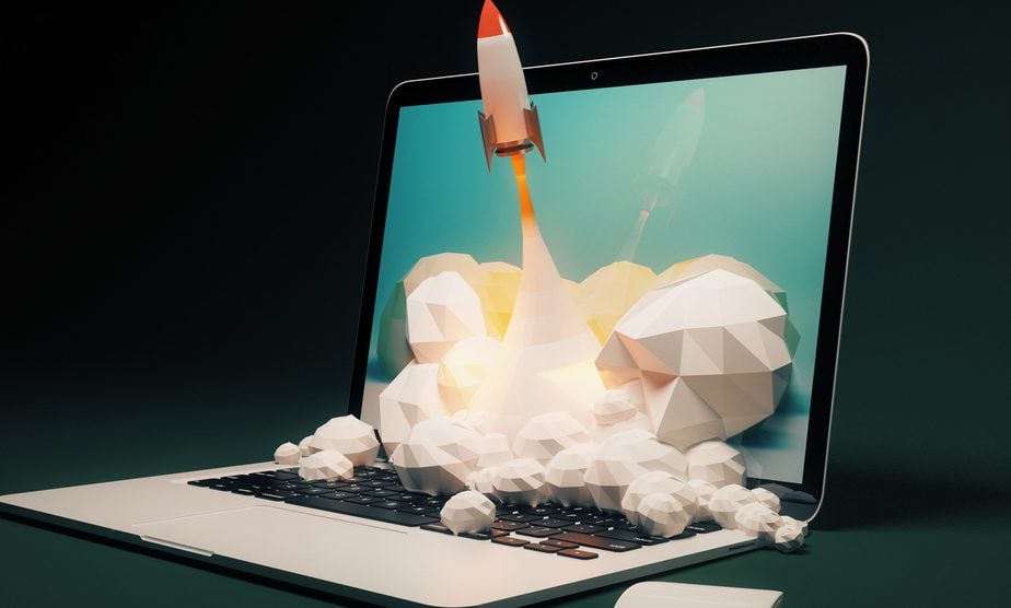 A rocket launching out of a laptop monitor