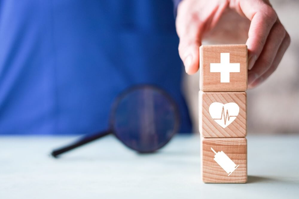 medical search_Doctor hand arranging wood block stacking with icon healthcare and medical, insurance for your health search
