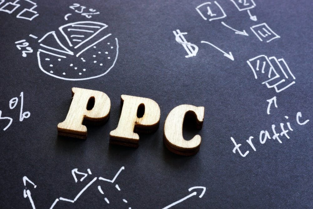 ppc marketing_PPC pay per click sign on black paper