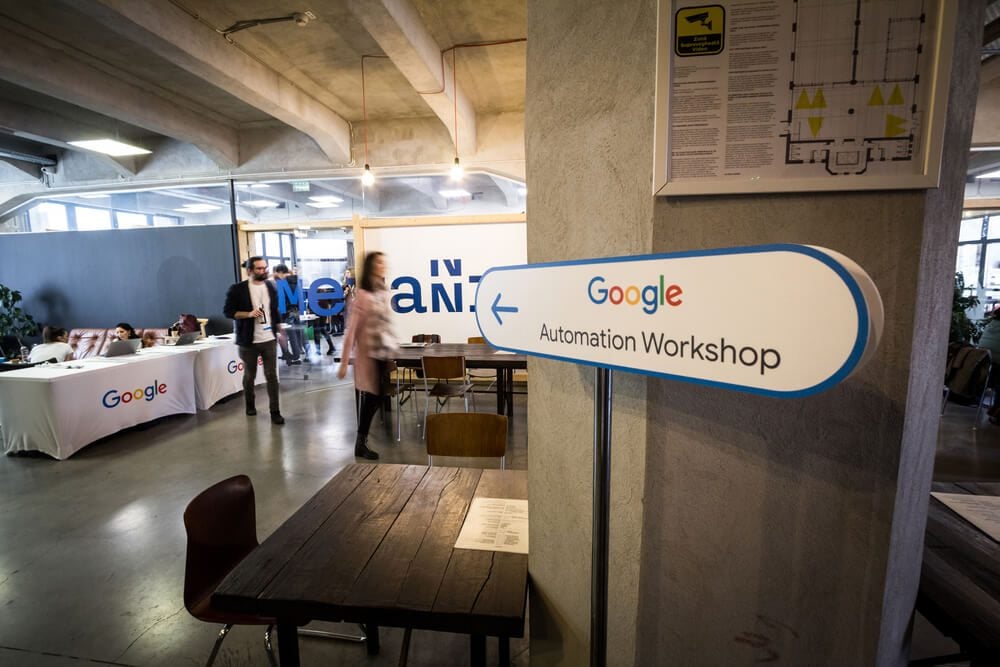ppc agency_BUCHAREST, ROMANIA - FEBRUARY 12, 2020: Google logo on entrance of a workshop on automated bidding. Google Partners is a program between Google & marketing agency for Google Ads PPC