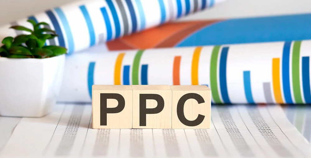 ppc strategy_Word PPC made with wood building blocks on the chart background