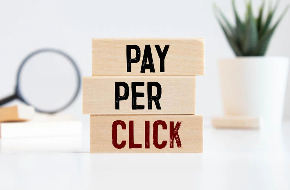 ppc_PPC Pay Per Click text on dices on wooden background.