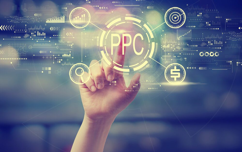 Best Practices for PPC Marketing - PPC - Pay per click concept with a hand pressing a button at night