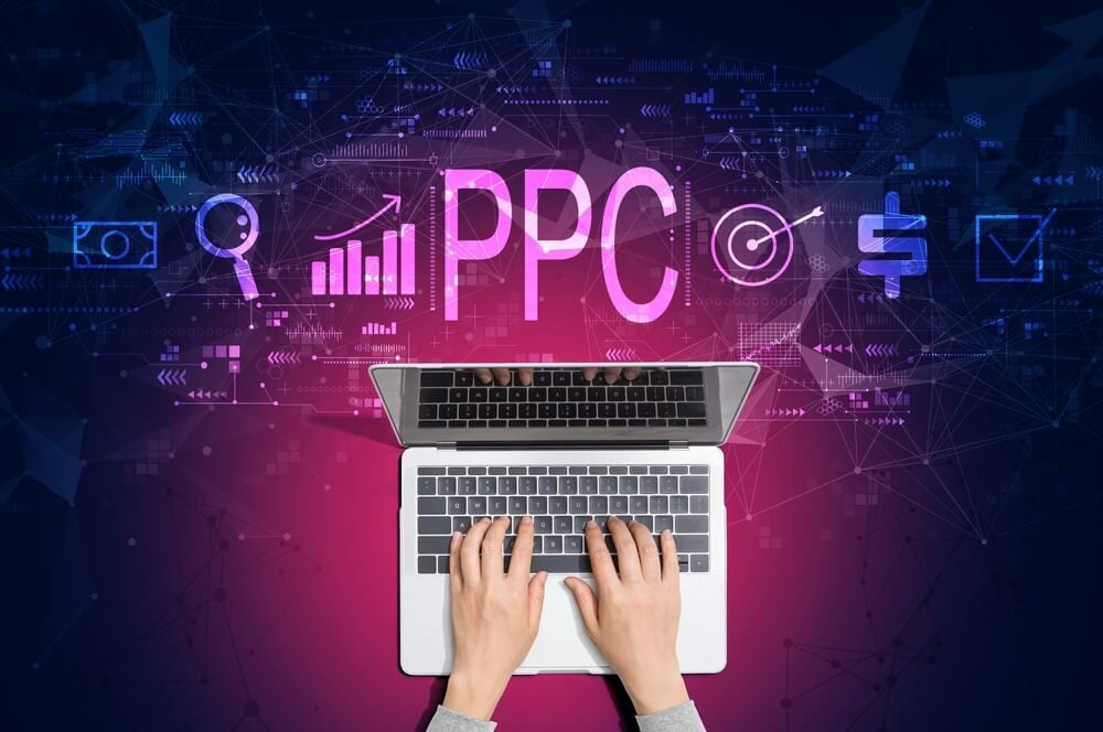 pay per click_PPC - Pay per click concept with person using a laptop computer