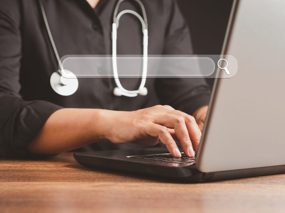 seo for doctors_Search engine online concept. Close-up of hand a doctor using laptop and internet for searching information on web browser