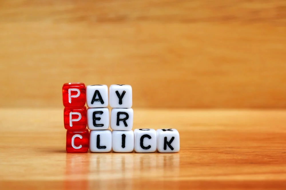 pay per click management_PPC Pay Per Click text on dices on wooden background
