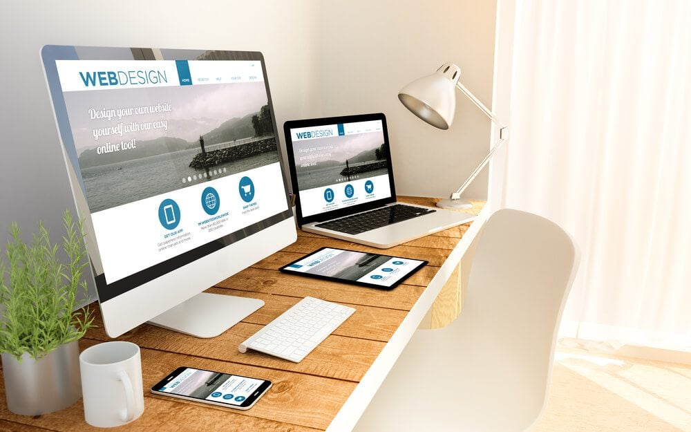 website design_Digital generated devices over a wooden table with responsive design website. All screen graphics are made up. 3d illustration.