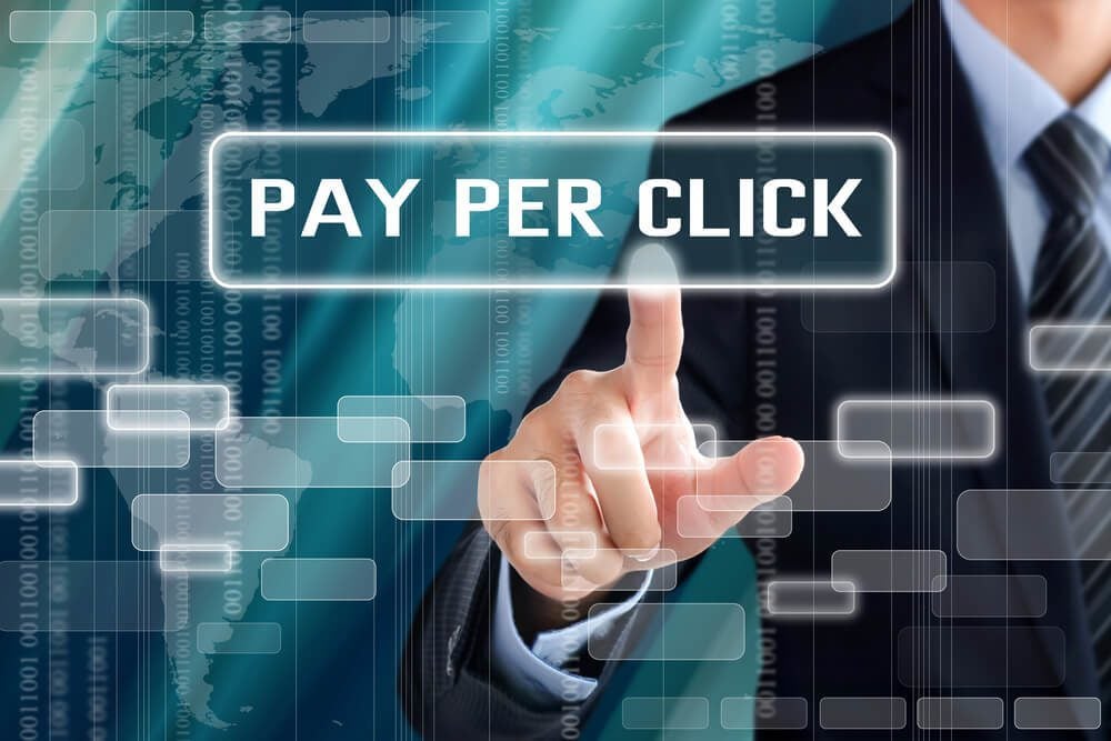 ppc_Businessman hand touching PAY PER CLICK (or PPC) sign on virtual screen