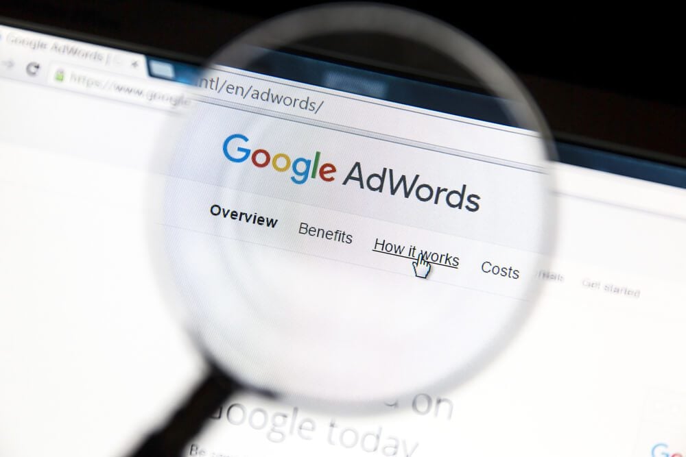 google adwords_Ostersund, Sweden - May 23, 2016: Google Adwords website under a magnifying glass. Google AdWords is an online advertising service
