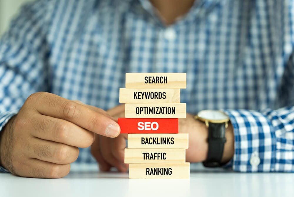 search engine optimization_Businessman Building SEO concept with Wooden Blocks